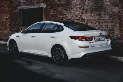 white bmw m 3 coupe parked beside brown brick wall