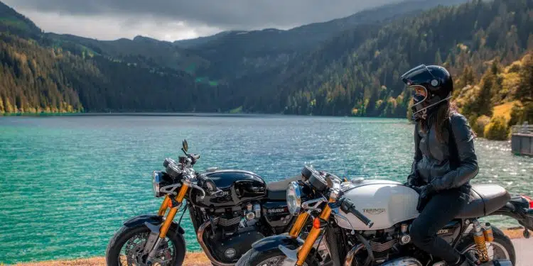 black and orange motorcycle near body of water during daytime